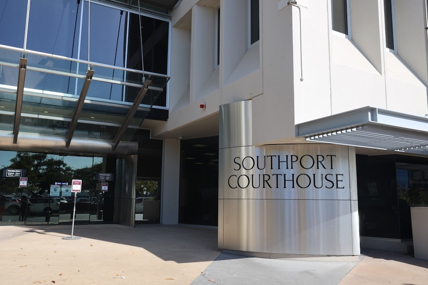 The front of a modern looking courthouse with a sign saying "Southport Magistrates Court".