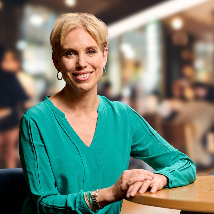 Renee Krosch sitting in a luxurious restaurant, leaning back against the back of a lounge.