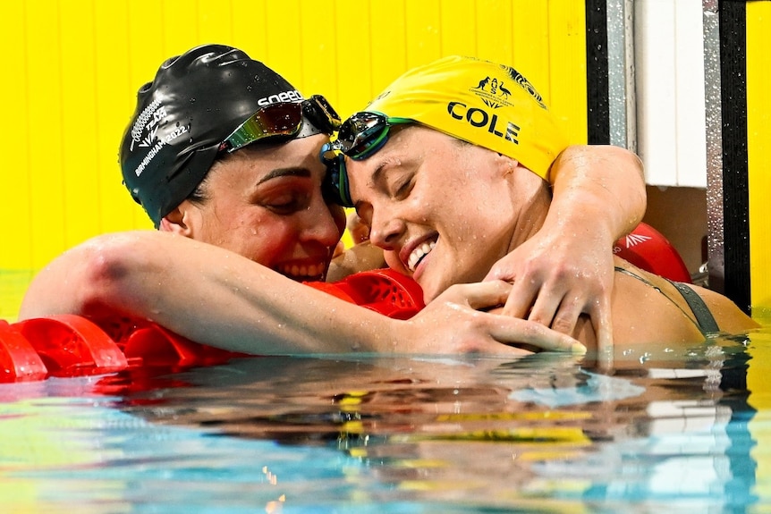 Sophie Pascoe and Ellie Cole hug in the water