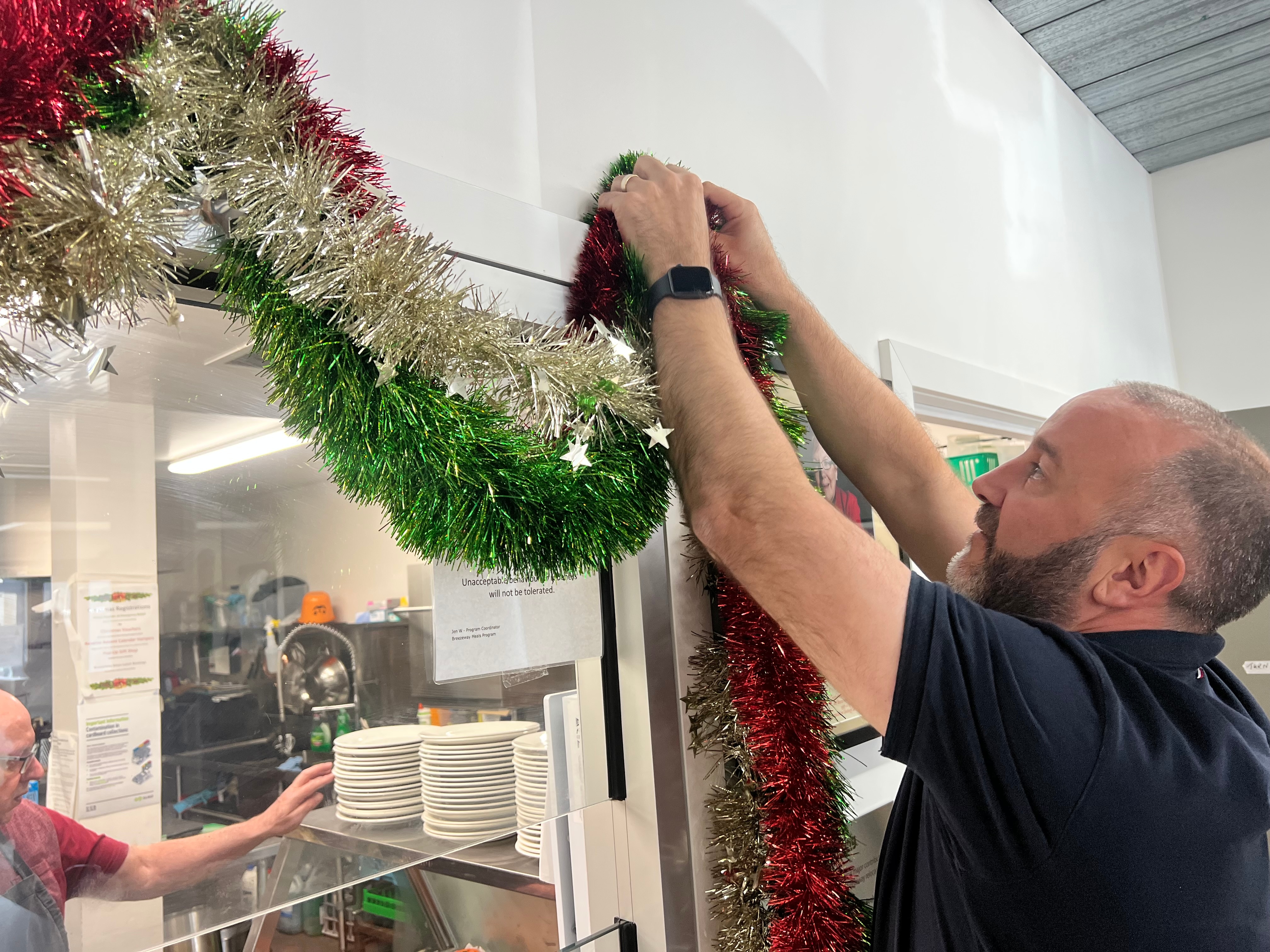 uniting ballarat senior manager of community engagement and support warrick davison hanging christmas decorations