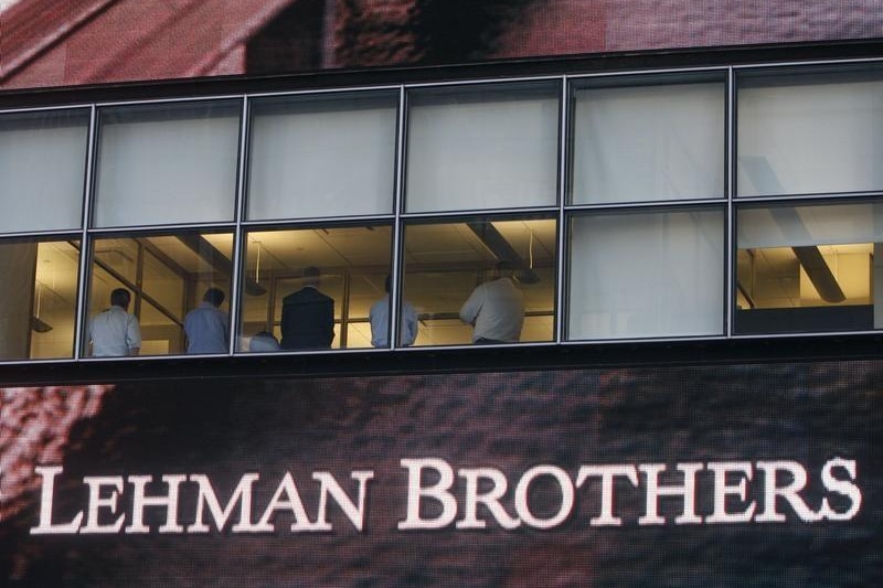 People sit in the window at the Lehman Brothers building in New York September 15, 2008.