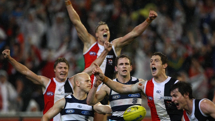 The Saints rejoice at the final siren as they celebrate around dejected Cats pair Gary Ablett and Joel Selwood