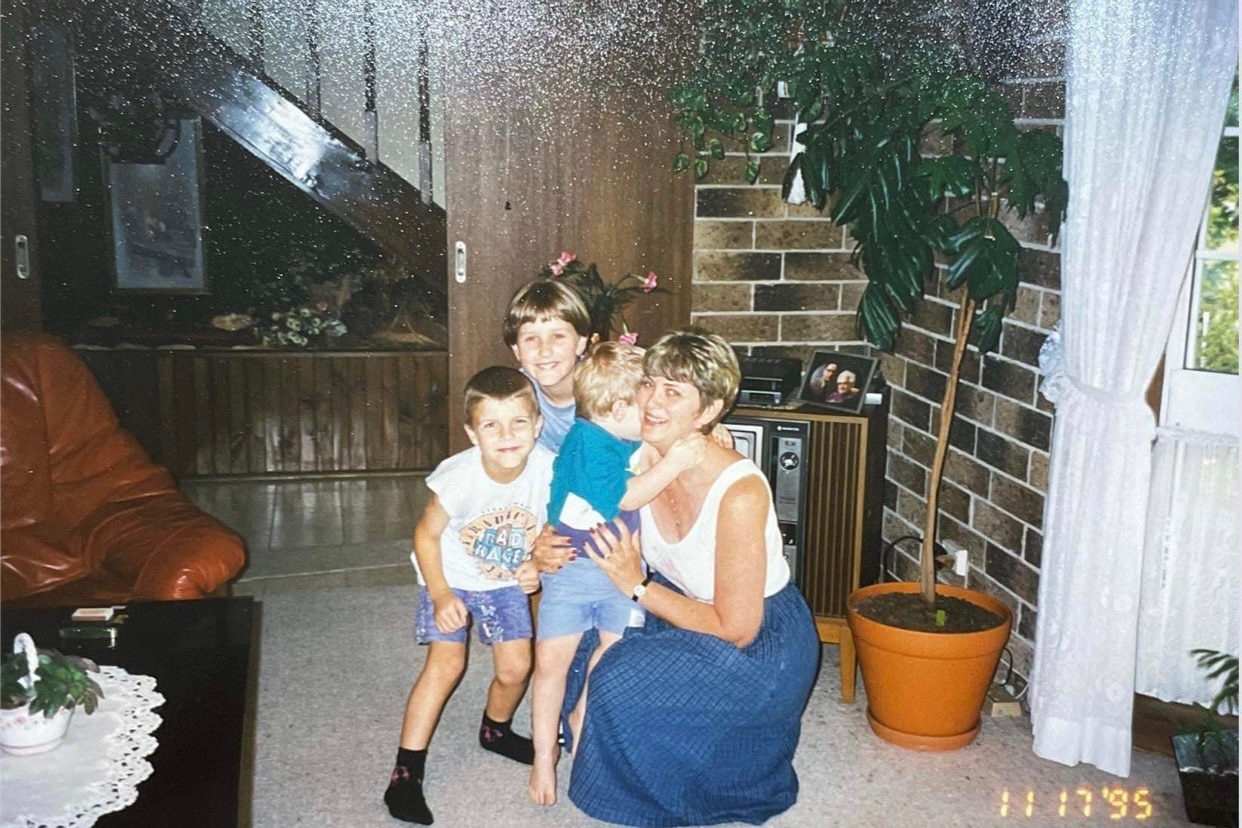 An older photograph of Rosemarie Campbell when she was younger with three children. 