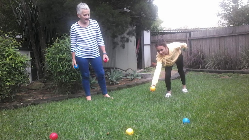 Wendy Lawson and her grand-daughter Gabby playing boule in the backyard