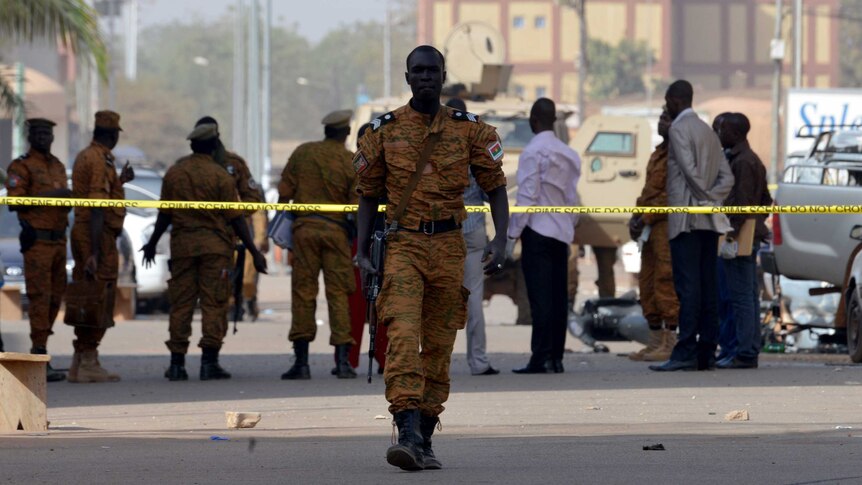 Burkina Faso's soldiers and investigators gather in front of the Splendid hotel.