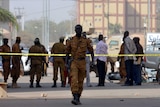 Burkina Faso's soldiers and investigators gather in front of the Splendid hotel.