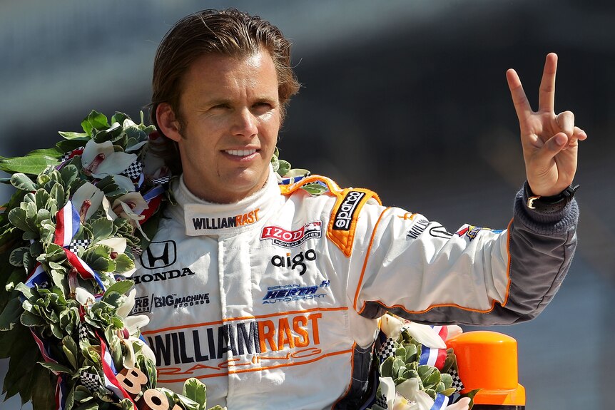 Indy driver Dan Wheldon gestures to photographers during the 95th Indianapolis 500 Mile Race Trophy Presentation.