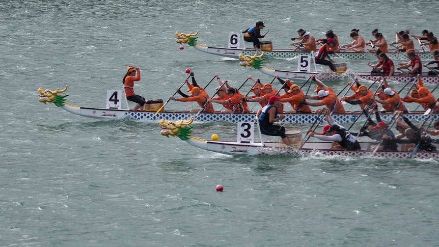 Dragon boat world championship competitors race towards the finish line at West Lakes.