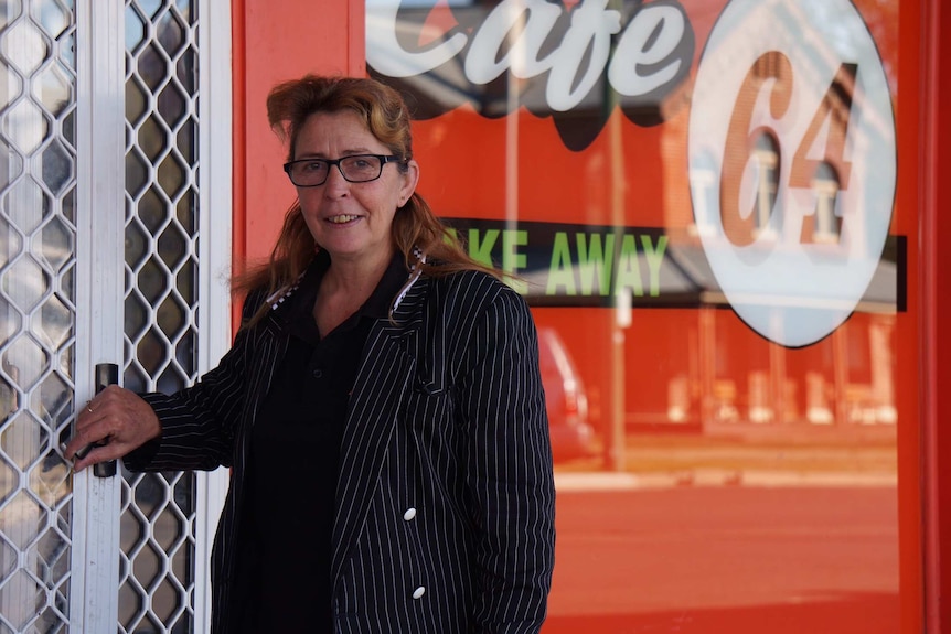 Katie Hook stands at the entrance to her cafe in Walgett.