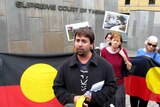 Adam Thompson and Aboriginal Centre supporters gather outside court.