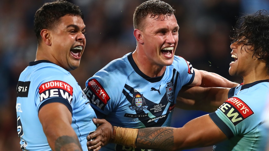 Two rugby league players celebrate a try 