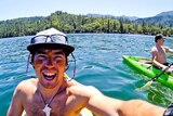 John Chau smiling while kayaking.