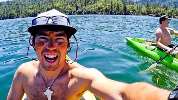 John Chau smiling while kayaking.