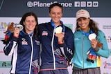 Three medallists in the women's C1 stand on the podium at the 2023 ICF Canoe Slalom World Championships.