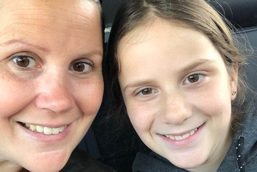 A close up photo of Caitlyn Royce and her mother Melanie, both smiling.