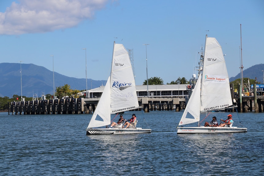 two sailboats on the water