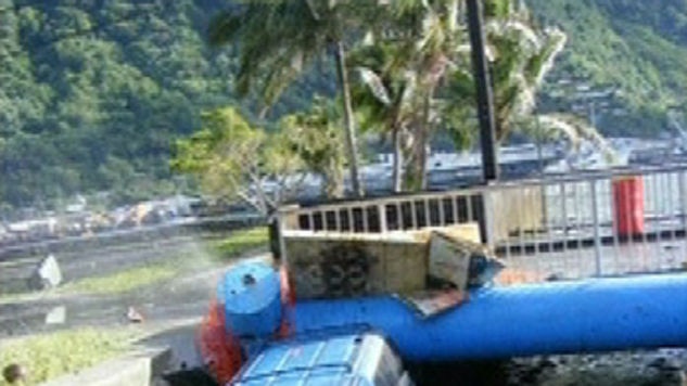 A car lies in a canal in a town in American Samoa in the wake of the tsunami