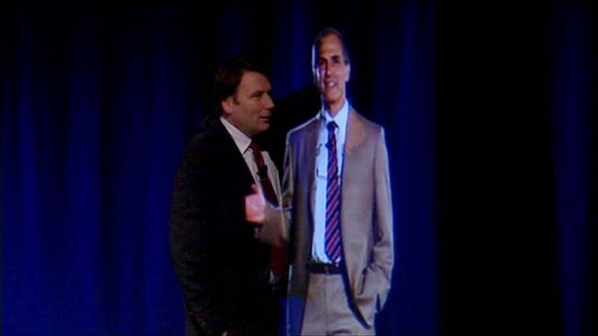 A hologram of Dr Hugh Bradlow, right, appears at a business conference