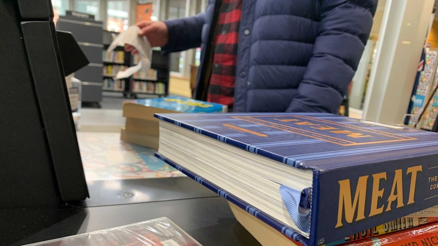 A borrow borrows a raft of books at a library in Ballarat