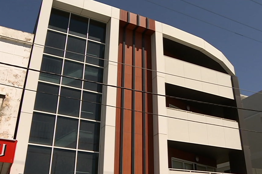 The outside of an apartment building with combustible cladding.