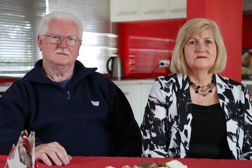 An older couple, Robert and Patricia Earle, sitting in their kitchen at their home in Sydney.