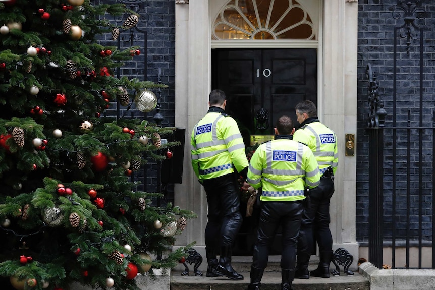 Police officers stand outside 10 Downing Street in London.