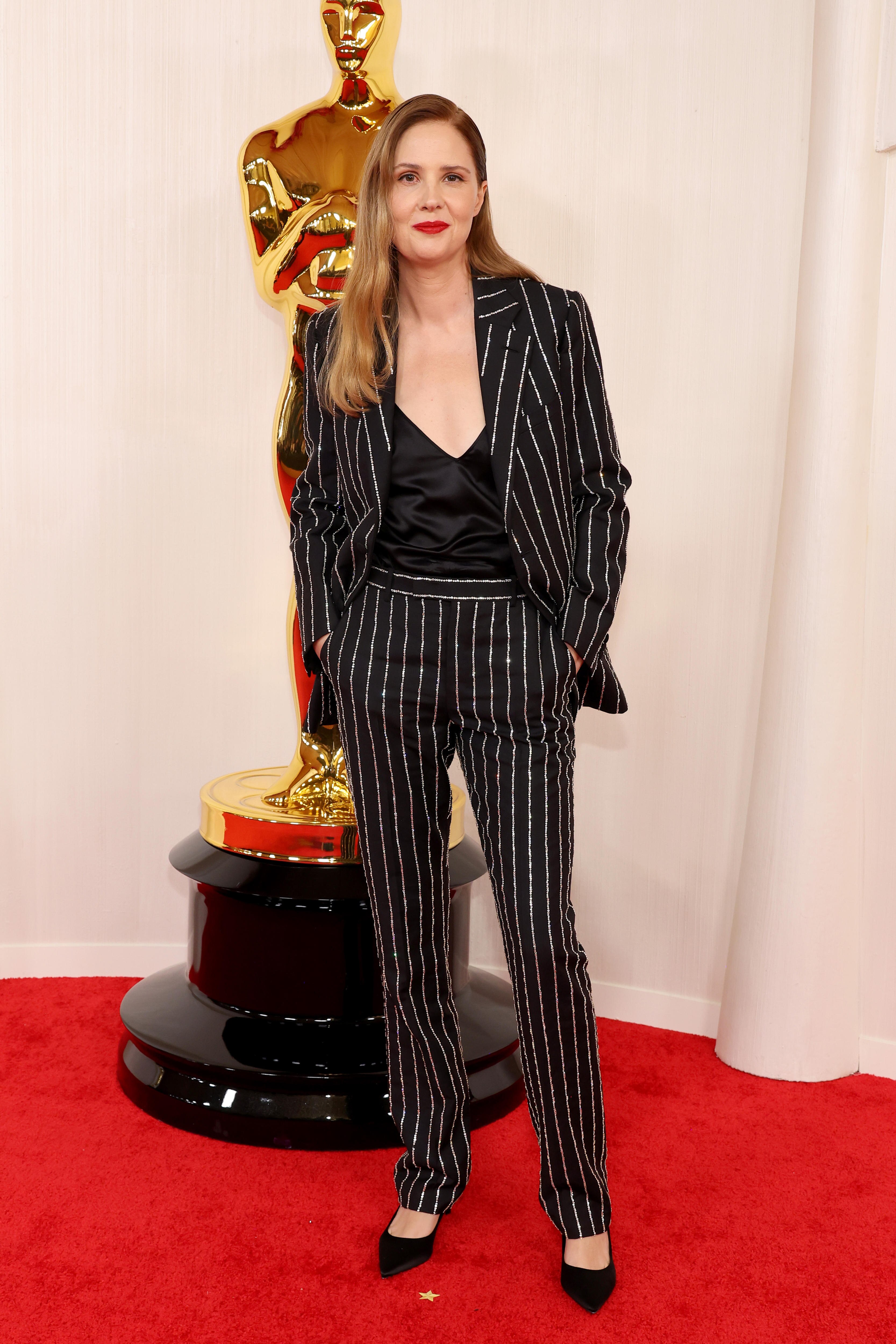 Justine Triet poses on the Oscars red carpet.