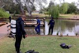 Water police have been searching at Kapunda for clues to help solve three brutal murders