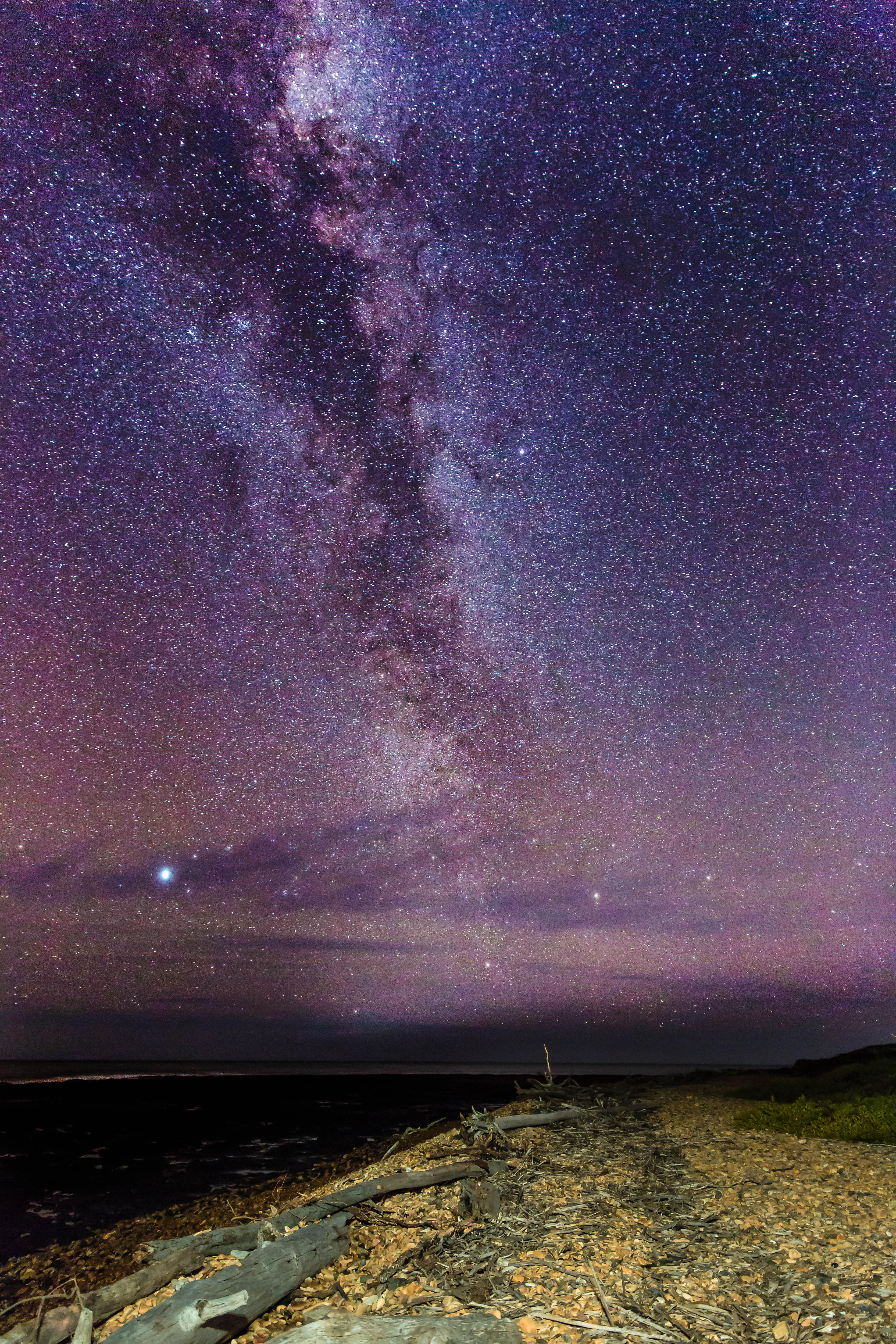 The milky way in the night sky as seen from a beach.