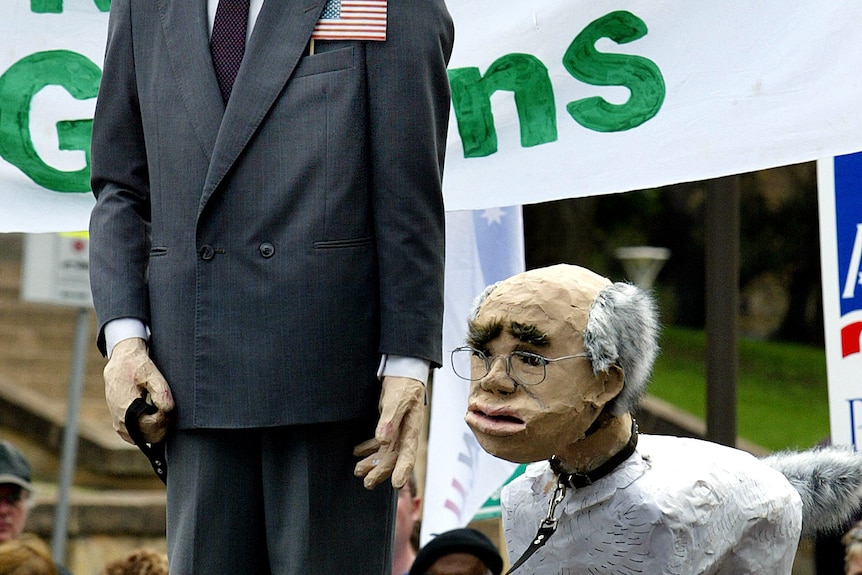 Effigies of US president George W Bush and the head of PM John Howard on the body of a dog being walked by Bush