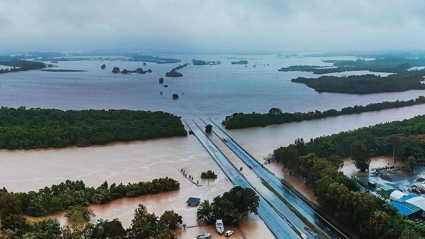 An aerial image shows flooded roads and fields in Cairns.