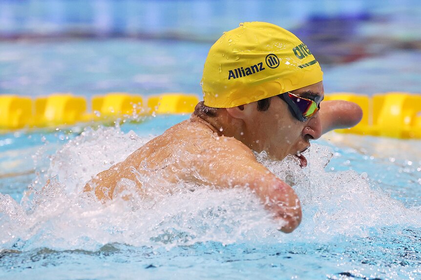 An Australian swimmer goes through the water while competing in a Para Sport swimming race.