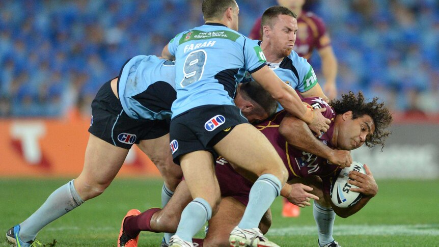 NSW players tackle Queensland's Sam Thaiday