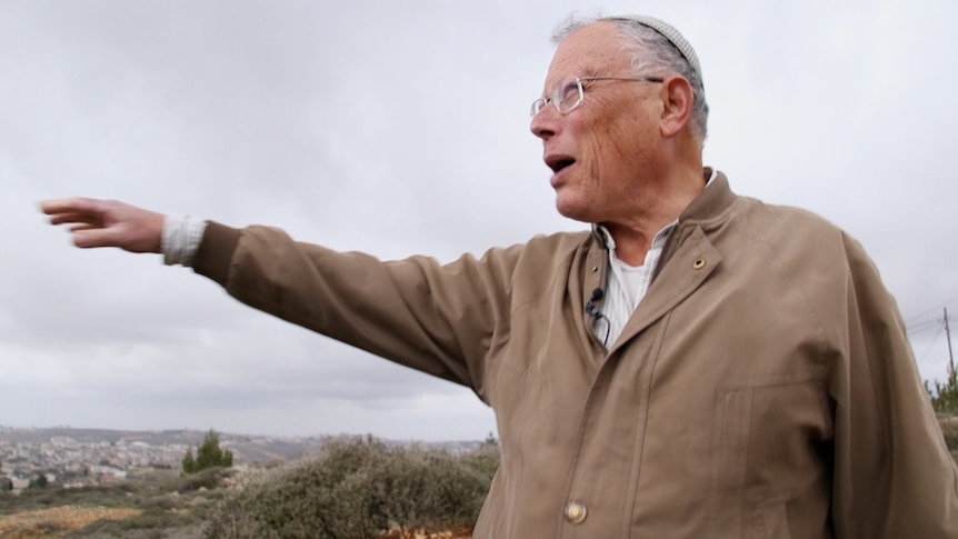 Dr Hagai Ben-Artzi on high ground, gesturing out across the land below
