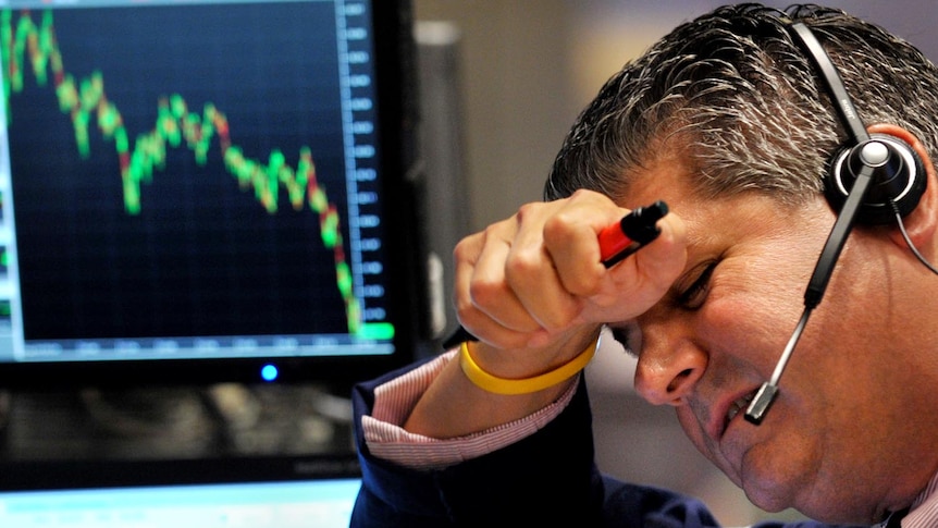 A trader shows the pressure on the floor of NYSE