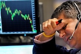 A trader shows the pressure on the floor of NYSE