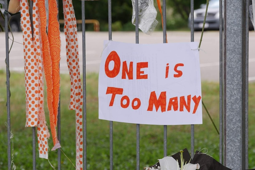 A sign saying "one is too many" at the scene where Jennifer Board was killed in Townsville.