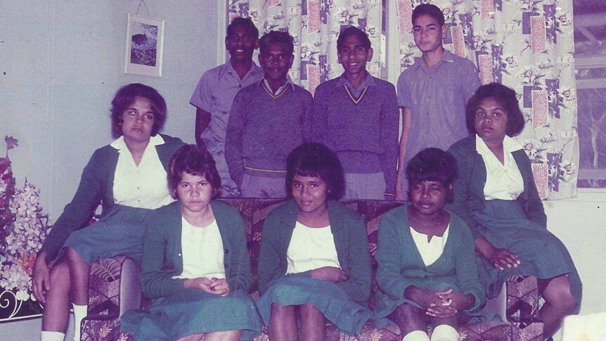 Indigenous teenagers in school uniform in two rows, boys at the back, girls at front.