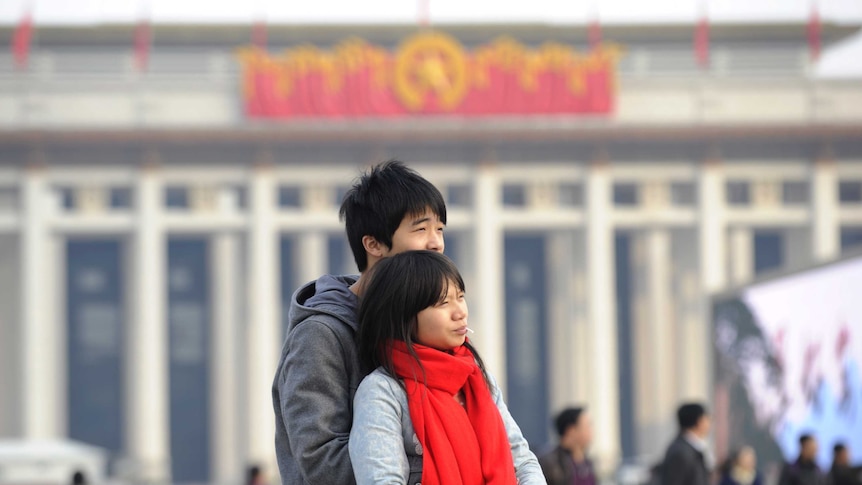 A Chinese couple hug each other.