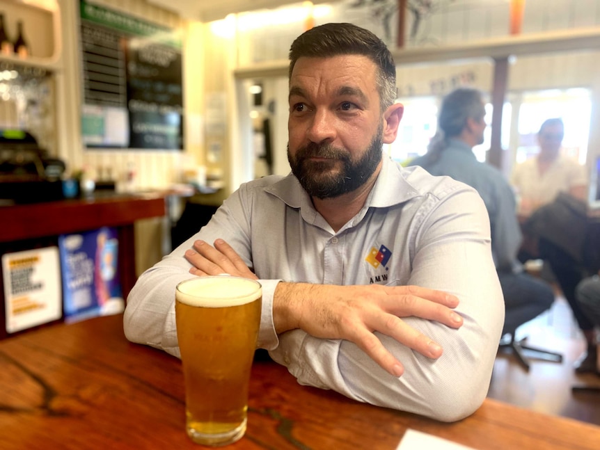 AMWU NSW secretary Steve Murphy drinking a beer at a bar.