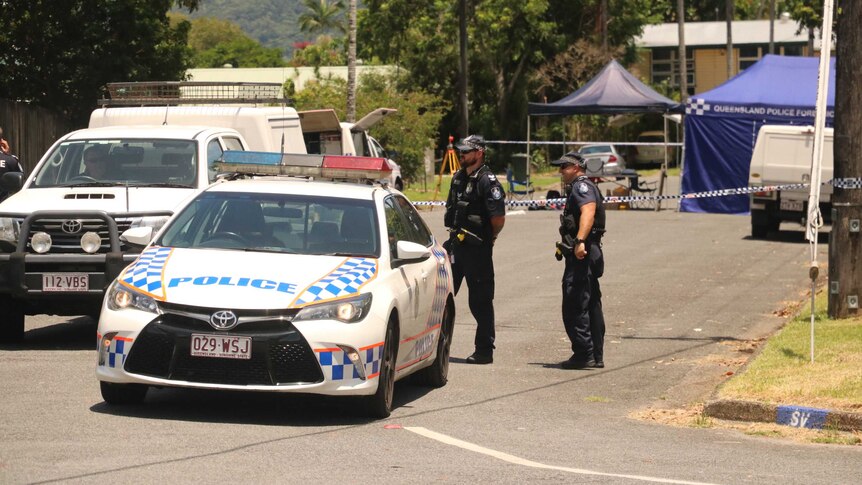 Police cars and officers at a crime scene in Cairns.