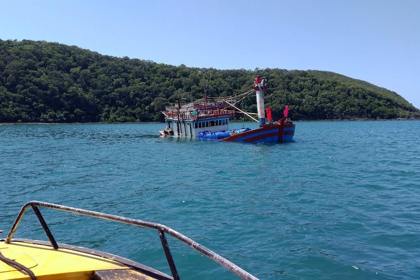 Partly sunk suspected illegal fishing boat in waters off Cape Kimberley in the Daintree.