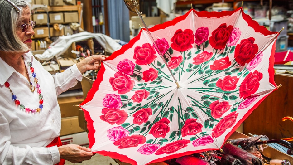 Designer, Ms Mora-Hyde opens one of her rose umbrellas.
