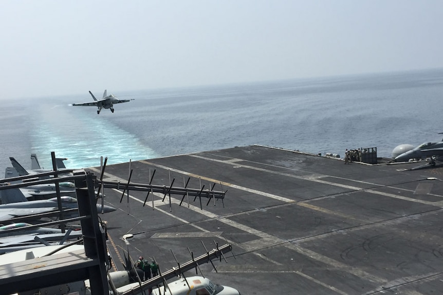 A plane comes in to land on the USS Carl Vinson