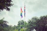 UK flag and an LGBTQI rainblow flag being flown.