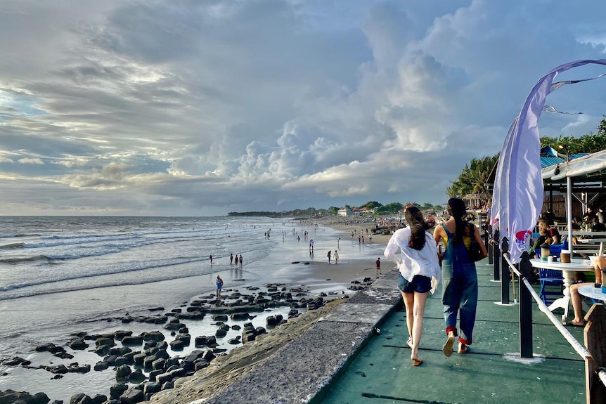 two person walking in a pathway in Canggu Beach in Bali 