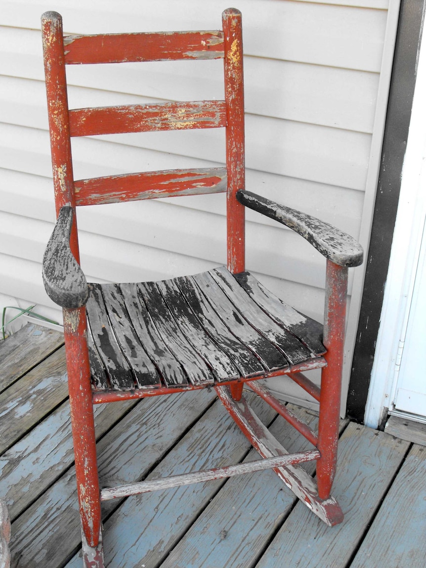 An old rocking chair on a verandah.