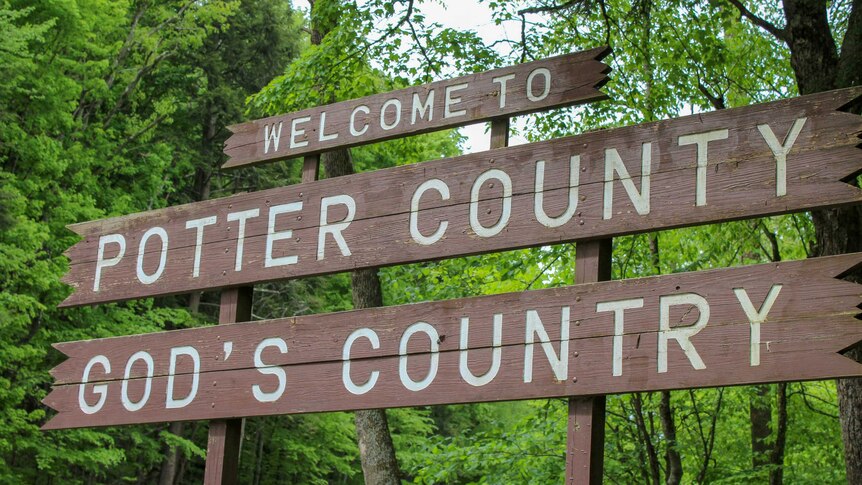 A sign reading "Welcome to Potter County, God's Country"