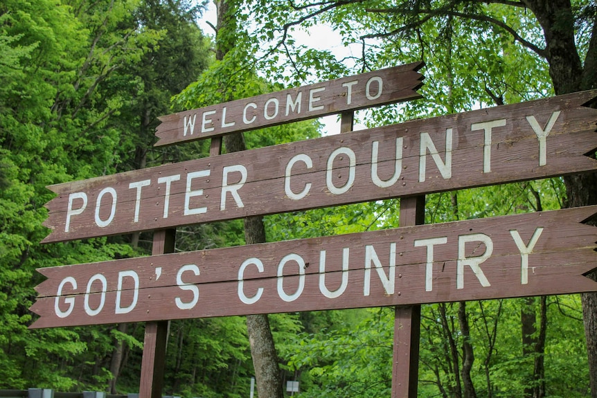 A sign reading "Welcome to Potter County, God's Country"
