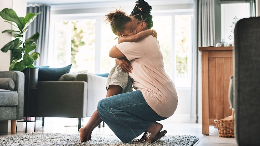 woman hugs child in living room